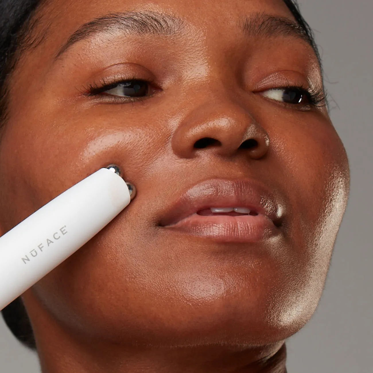 NuFACE FIX MicroWand lifestyle photo showing the product in use