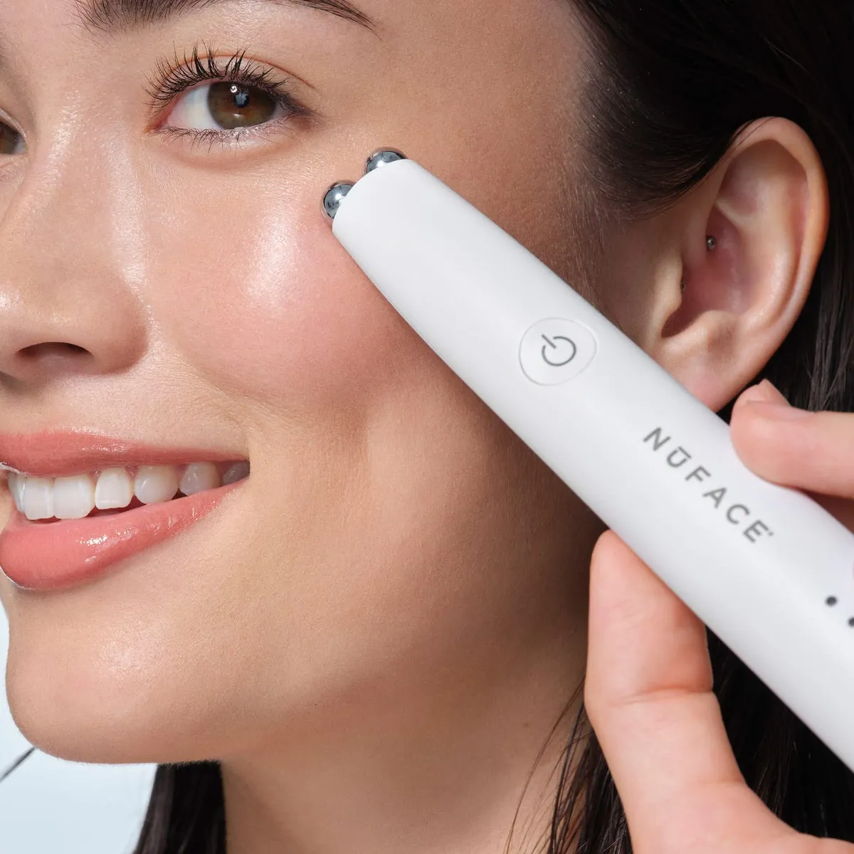 NuFACE FIX MicroWand lifestyle photo showing the product in use