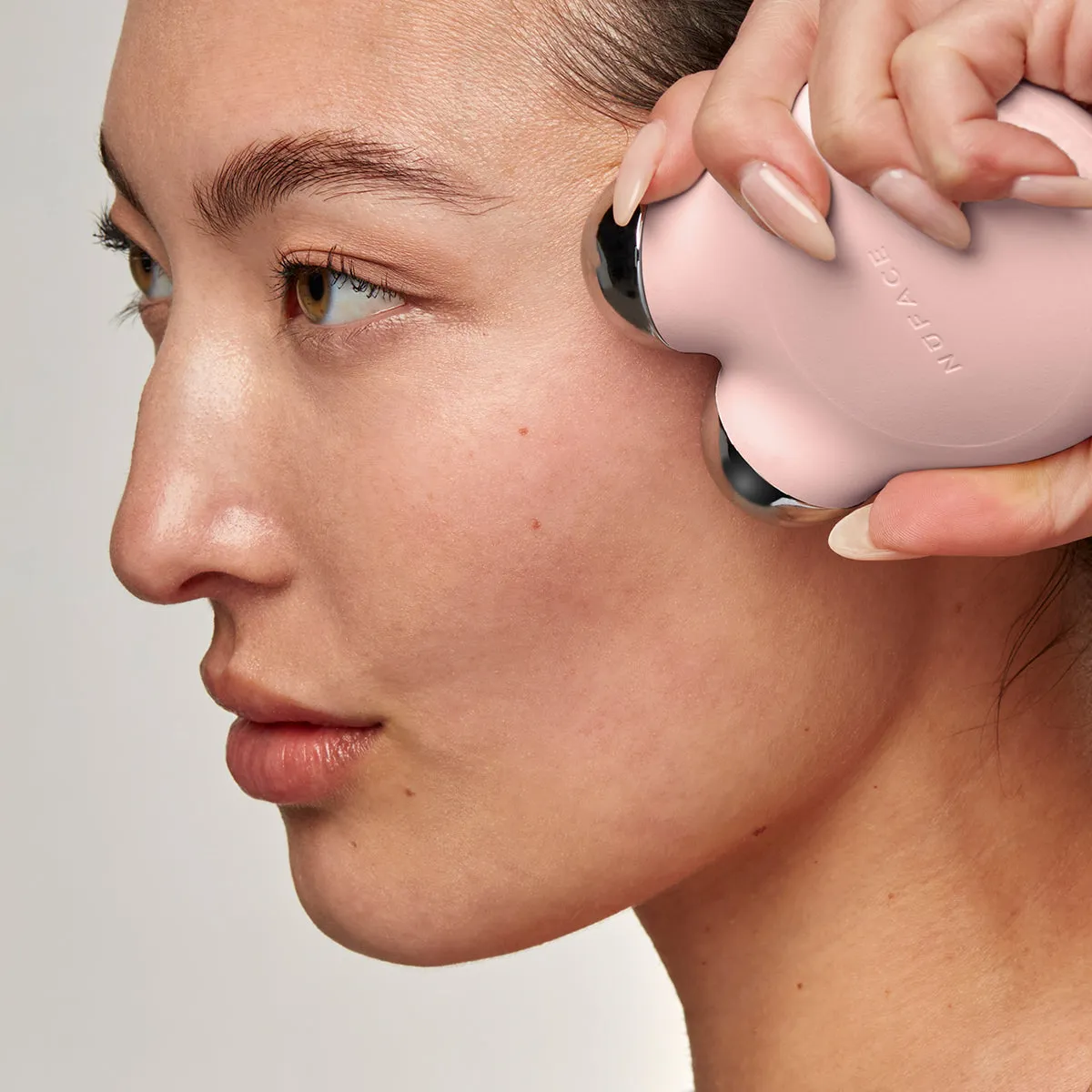 NuFACE MINI+ Starter Kit lifestyle photo showing the product in use