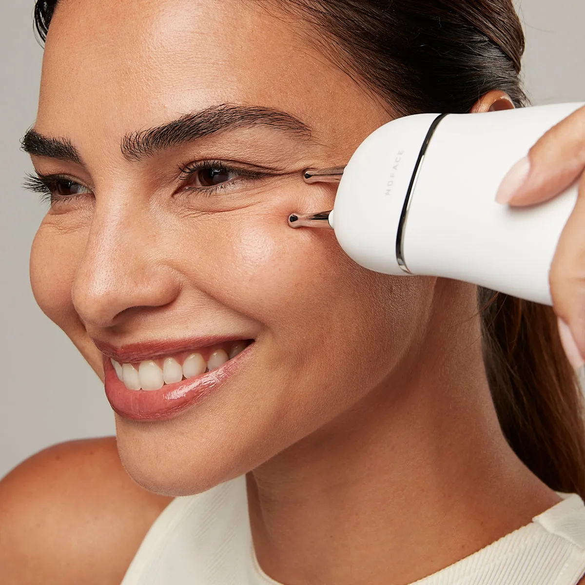 NuFACE TRINITY+ Effective Lip & Eye Attachment lifestyle photo showing the product in use